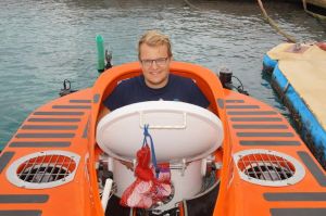 Smiling before I drop down into the Curasub for my first submarine ride