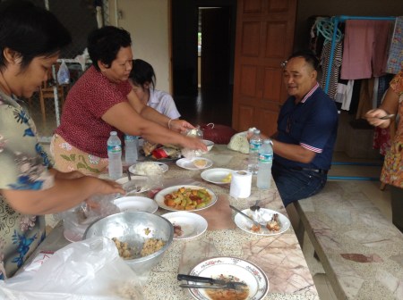 My family and neighbors packing all the leftover food Billy and I could finish for breakfast for our lunches...Yum!!