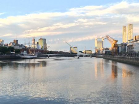 On the other side from the fireworks is the famous Puente de la Mujer. This bridge's name translates to "Woman's Bridge" and represents the woman's role in the tango with her leg extended from her body. In this picture you can see the "new" in Puerto Madero with its big apartment buildings and riverside dining but also the "old" as a still functional port.