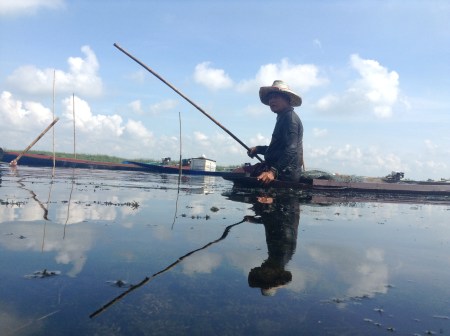 In an area affected by a dam construction, this man now fishes where homes used to be.
